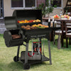 Black Royal Gourmet grill with food on a grassy outdoor area