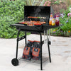 Royal Gourmet Portable barbecue grill with food and condiments on a patio
