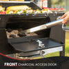 Royal Gourmet Grill with a front charcoal access door open, showing charcoal and tongs, with vegetables on the grill.