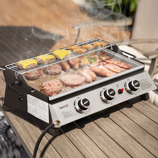 Royal Gourmet  Portable grill with food on a wooden surface outdoors