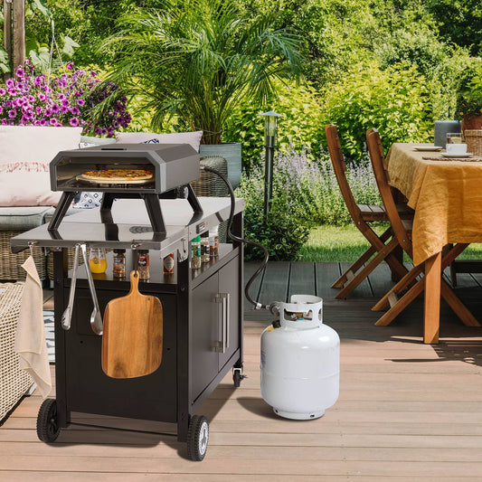 Outdoor patio with a Royal Gourmet  pizza oven, table, chairs, and gas tank on a wooden deck.