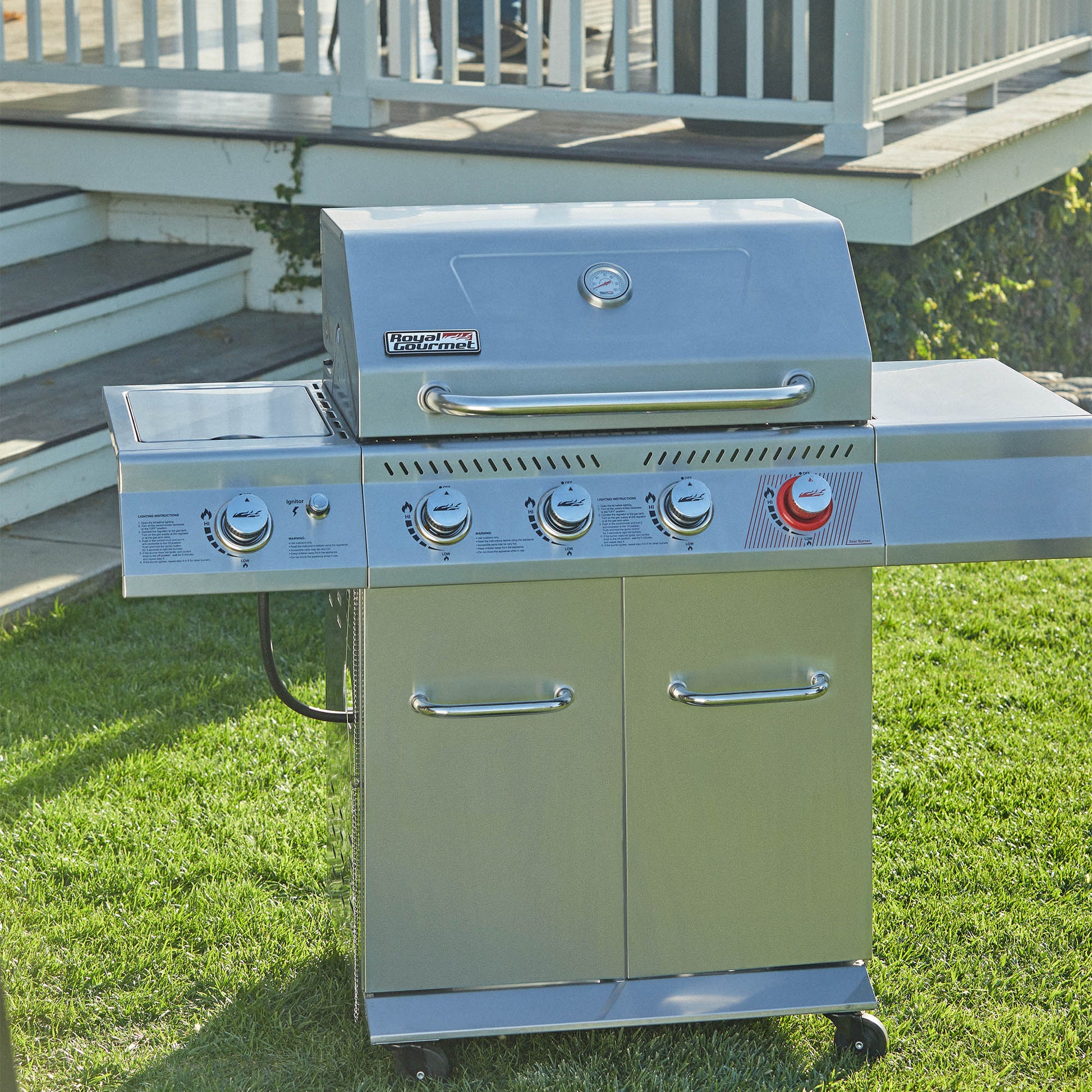 Royal Gourmet Stainless steel grill on a grassy area with a deck in the background