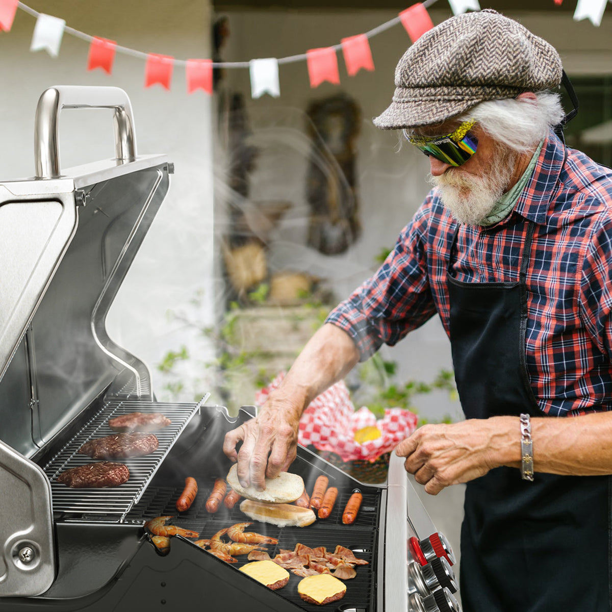 Man grilling food on a Royal Gourmet  barbecue grill outdoors with flags in the background