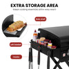 Black portable grill with labeled storage features: side shelf holding sliced bread, left basket, and hooks. Text at top reads 'EXTRA STORAGE AREA' and callout labels point to the shelf, left basket, and hooks.