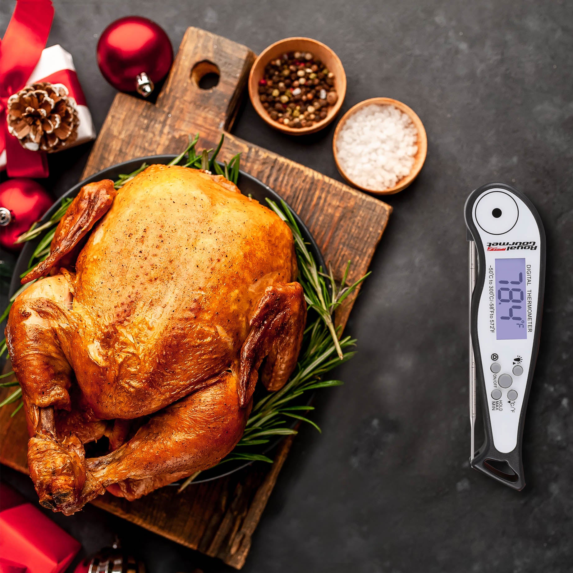 Roasted turkey on a Royal Gourmet wooden board with a digital thermometer displaying 168.1 degrees Fahrenheit.