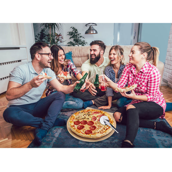 Group of friends enjoying pizza and drinks on a couch in a living room.