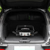 A compact black Royal Gourmet gas grill with a silver control panel is folded and displayed inside the open trunk of a black vehicle.