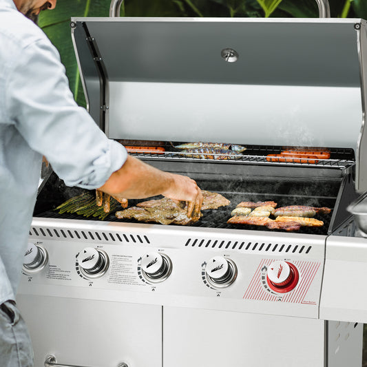 Person grilling on a large outdoor Royal Gourmet  grill with various meats and vegetables.