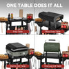 A 2x2 collage showing four tabletop cooking setups under the headline 'ONE TABLE DOES IT ALL': Prep Table, Pizza Oven Table, Electric Grill Table, and Charcoal Grill Table. Each panel shows a black metal table with built-in cooking surfaces, side storage, utensils, and food props on a white background.