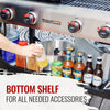 A stainless steel Royal Gourmet  outdoor grill with four black and red control knobs, a hand holding a bottle, and a bottom shelf holding bottles and containers. Text overlay at the bottom reads 'BOTTOM SHELF FOR ALL NEEDED ACCESSORIES'.