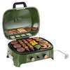 An olive green Royal Gourmet portable gas grill with its lid open, shown loaded with various foods including burgers, steaks, kebabs, skewers, and vegetables on a white background.