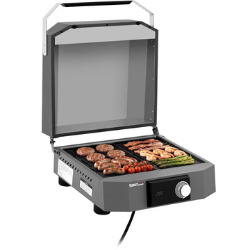A compact Royal Gourmet electric grill with its lid open, shown cooking sausages, shrimp, asparagus, and cherry tomatoes on a clean white background.