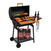 A black Royal Gourmet charcoal grill with an open lid, wooden side table, and wheels, shown loaded with food, bottles, utensils, and two bags of Royal Gourmet charcoal on a white background.