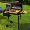 Royal Gourmet Barbecue grill with food on a grassy outdoor setting