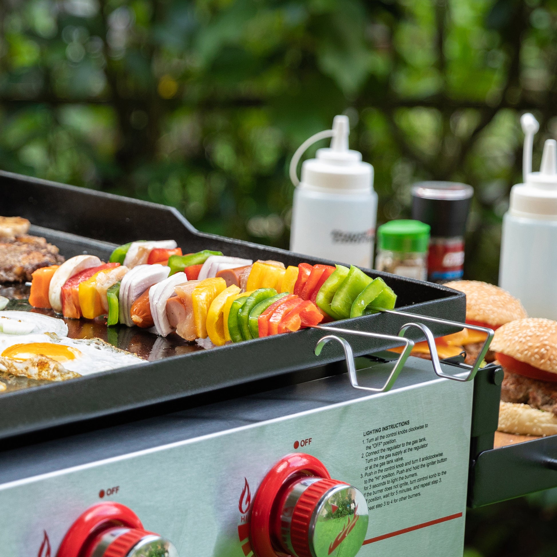 Royal Gourmet  Grill with skewers of vegetables and burgers on a outdoor setting
