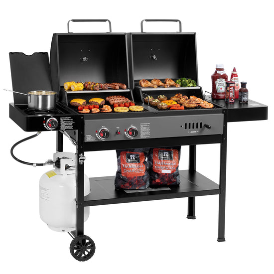 A black Royal Gourmet double-grill propane barbecue system with two cooking compartments, side shelves holding food, condiments, a pot, and a white propane tank on a clean white background.